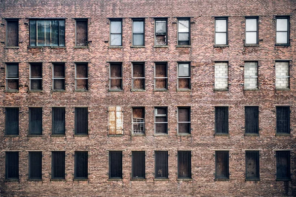 Vista frontal de um arranha-céus de tijolos abandonados a partir das janelas da rua em Nova Iorque . — Fotografia de Stock