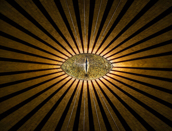 Golden all-seeing anonymous eye with lines and lights abstract religion background