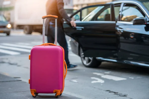 車に空港と読み込み機内持込の荷物袋からタクシーを取る人。街の通り上の荷物。旅行の概念. — ストック写真