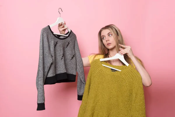 Woman choosing her fashion outfit. Girl thinking what to wear after the shopping. — Stock Photo, Image