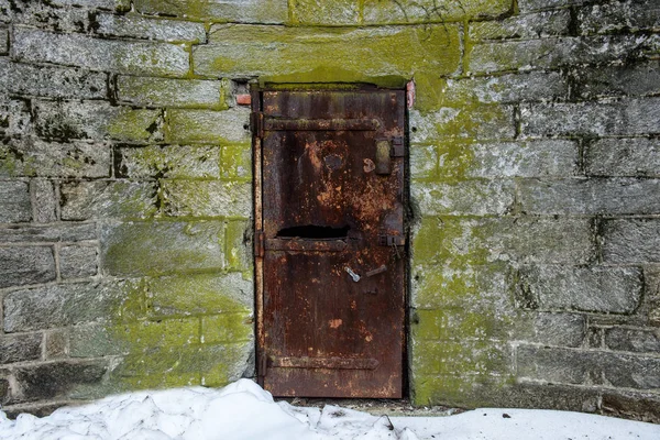 Alte verlassene Metalltür mit Rost in Burgmauer — Stockfoto
