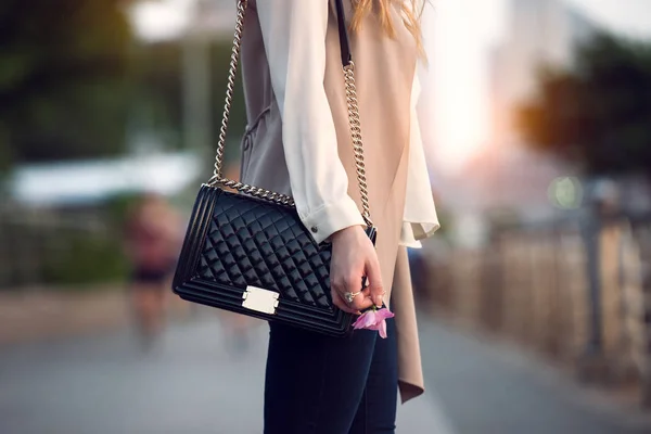 Közelről, szabadban elegáns női fekete bőr táska. Divatos és a luxus stílus drága női táska. — Stock Fotó