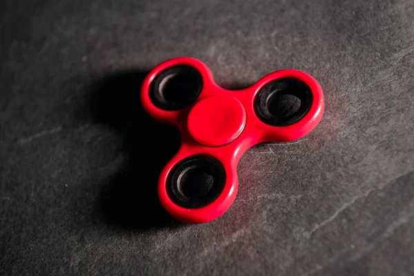 Red spinner Fidget finger stress anxiety relief toy — Stock Photo, Image