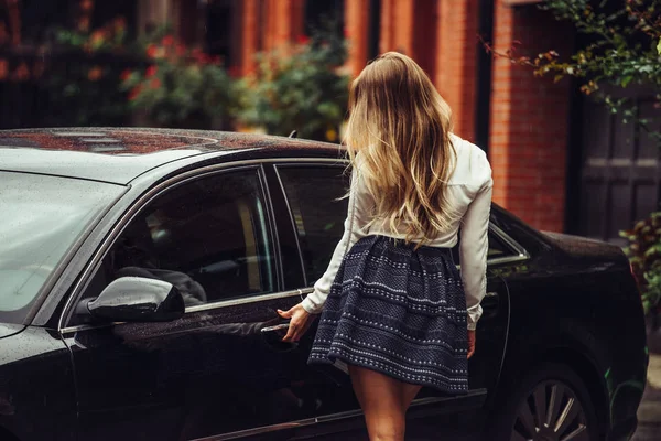 Concept photo of luxury and successful sexy businesswoman life going to drive her black elegant car — Stock Photo, Image