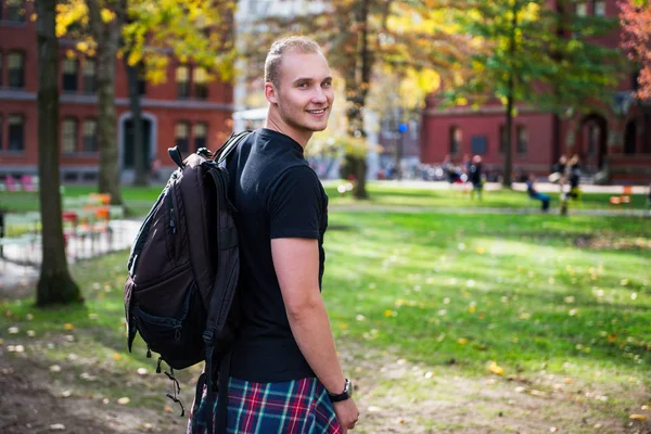 Gelukkig lachend student man met rugzak gaan studeren in universiteitscampus — Stockfoto