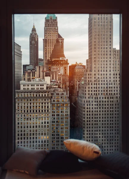 Luxury cozy window sill with view to New York City skyscrapers at sunset time. Coffee drinking place.