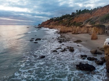 Scenic ocean beach with rocks in Malibu, California. clipart