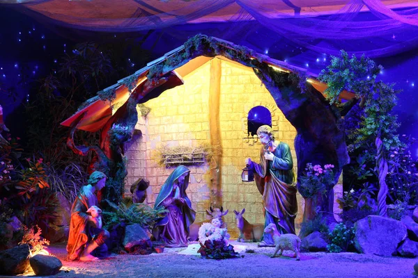 Christmas nativity scene with figurines including Jesus, Mary, Joseph, and sheeps