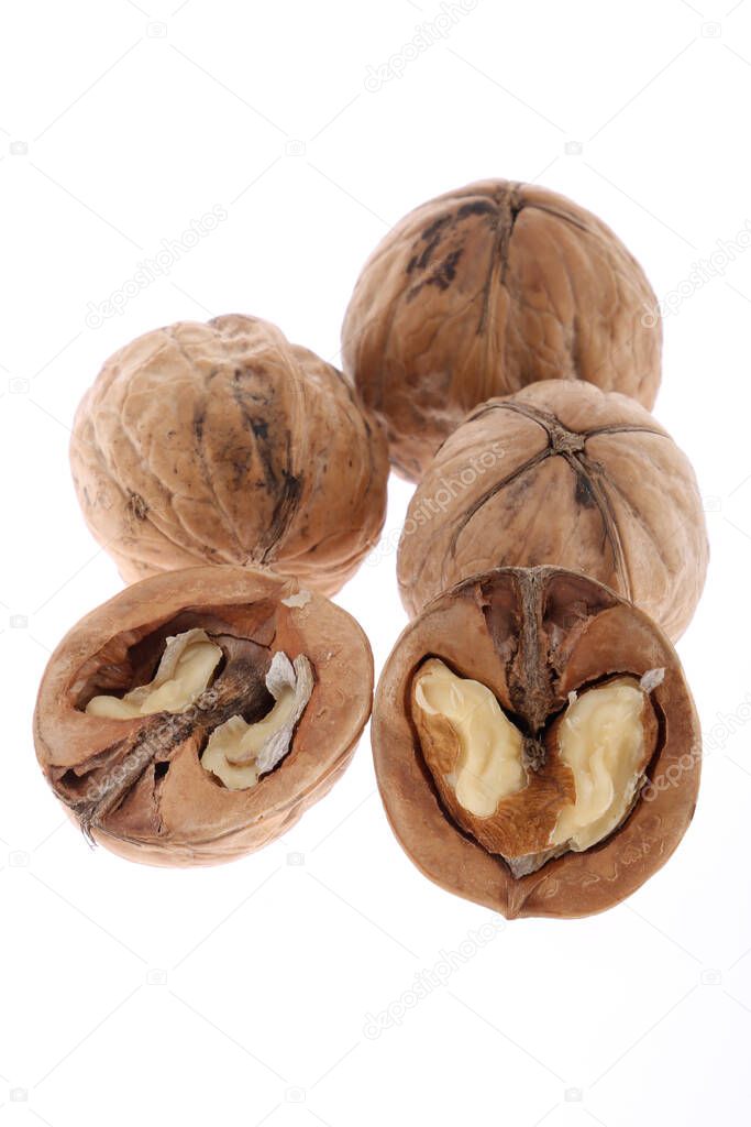 Whole and cracked walnuts isolated on white background
