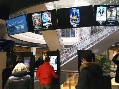 Automatic terminals for the purchase of cinema seats in a French clipart