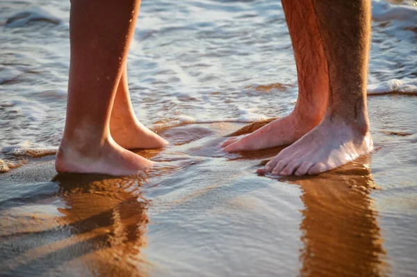 休暇だ カップルの散歩 抱擁を愛し 日没時にビーチでキス 2人の恋人 男性と女性は裸足で水の近く 夏の愛 自然の屋外の背景 — ストック写真