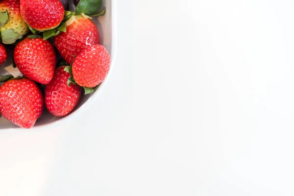 Fresh mixed sweet fruit on plate over white — Stock Photo, Image