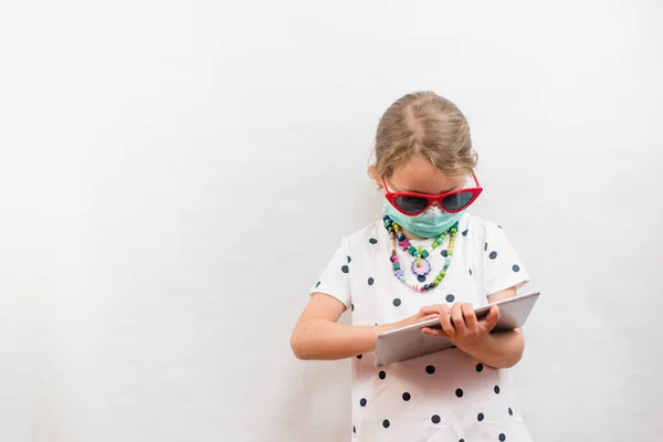 Little Blond Girl Wearing Disposable Mask Sunglasses Holding Tablet White — Stock Photo, Image