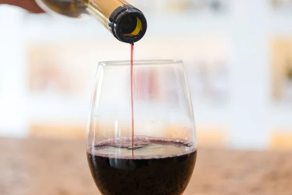 Red Wine pouring in a glass and Bottle — Stock Photo, Image