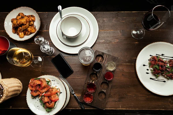 bar food and beer on wood table