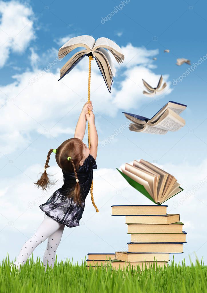 Education creative concept , child girl fly on book