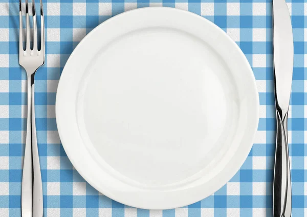 Table setting, empty plate and silverware on towel, top view — Stock Photo, Image