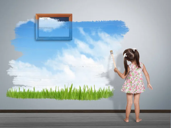 Child girl with paint brush painting wall in color of nature — Stock Photo, Image