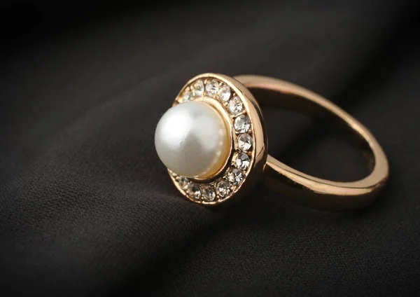 Jewelry ring with pearl on black cloth, soft focus — Stock Photo, Image