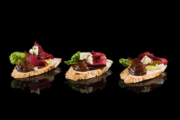 Bruschettas with beef and cheese — Stock Photo, Image