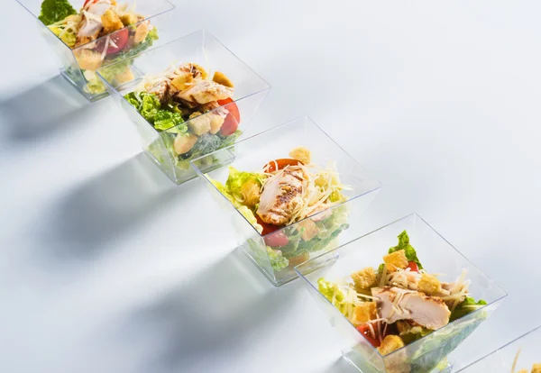 Salad with chicken and crackers in glass