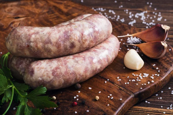 Raw sausages with garlic and parsley — Stock Photo, Image