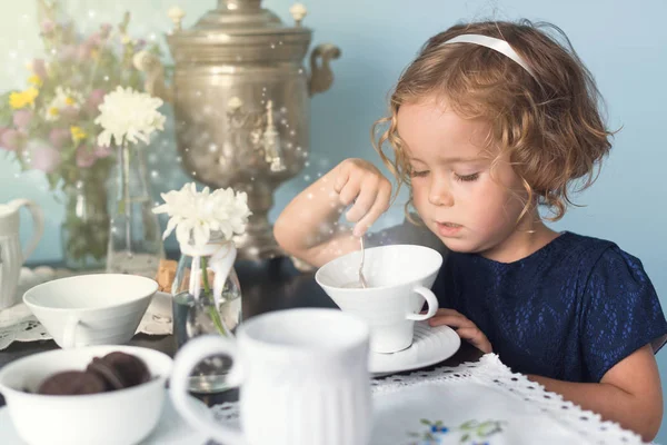 Волшебная чаепитие с маленькой кудрявой девочкой — стоковое фото