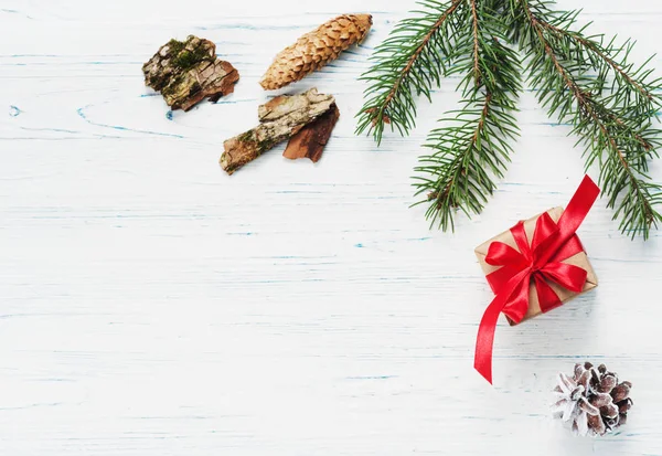 Presente de Natal, cobertor de malha, cones de pinho, ramos de abeto — Fotografia de Stock