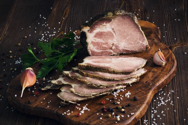 Domuz kayrak kesme tahtası üzerinde wo otlar ile pişmiş soğuk dilimlenmiş