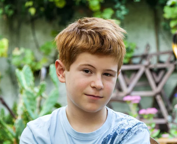 Portrait of cute smiling boy with red hair — Stock fotografie