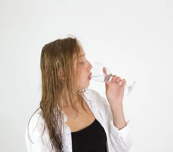 Young  girl with brown hair drinks water — Stock Photo, Image