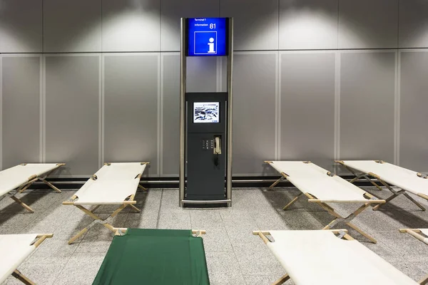 Lege kamp bedden staan rij per rij in de luchthaventerminal — Stockfoto