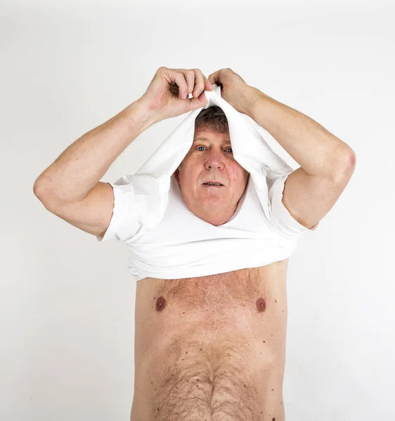 Portrait  of positive looking mature man while dressing up — Stock Photo, Image
