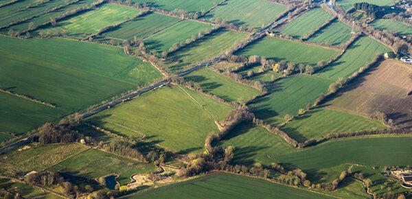 aerial view of green fields and slopes 