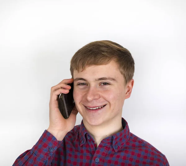 Menino adolescente olhando amigável usando o celular — Fotografia de Stock