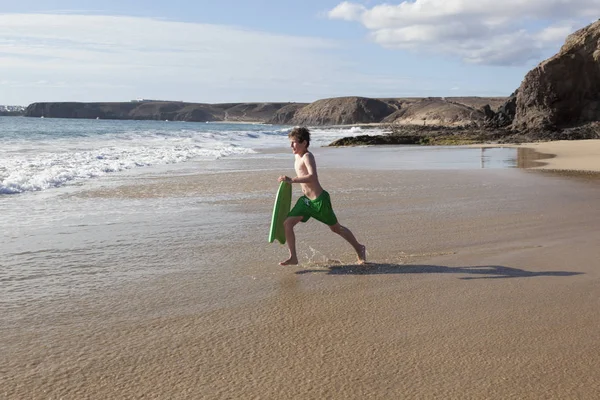 Jongen heeft leuke uitgevoerd met surfboard in de golven — Stockfoto