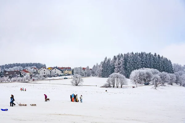 Hildren are skating at a toboggan run in winter on snow. — Stock Photo, Image