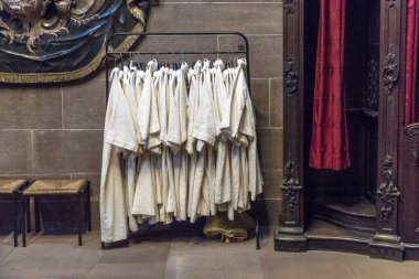 dress of catechumen teenagers hanging in the sacristy of the dom