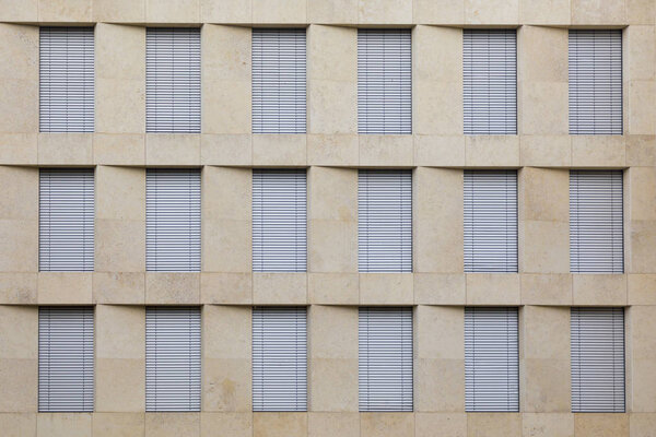 Facade of generic office building with closed shutter blinds