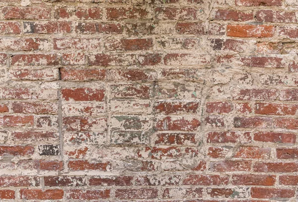 old grunge brick wall with peeled white color