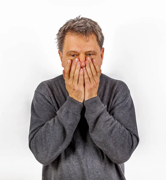 Astonished anxious man has hands in the face — Stock Photo, Image