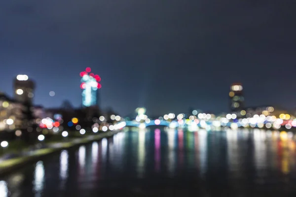 Blurred skyline of Frankfurt by night with river Main — Stock Photo, Image