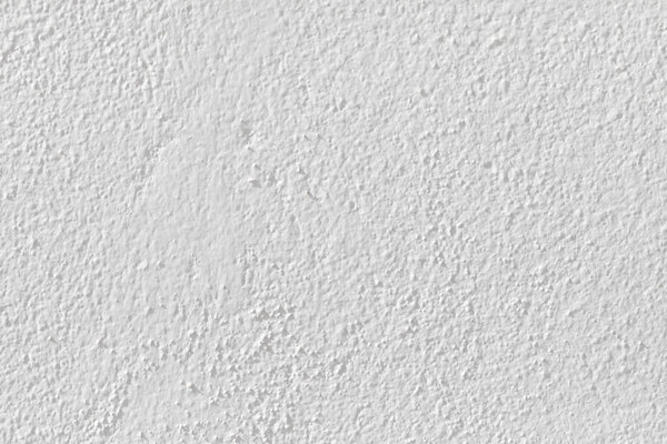 гипсовая стена белого цвета со структурой в качестве гармонического фона
