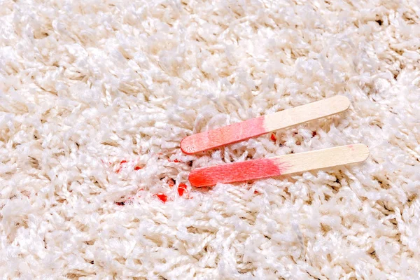 Red Popsicle melting on carpet — Stock Photo, Image