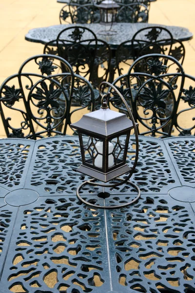 Vintage lantern with chairs and table — Stock Photo, Image