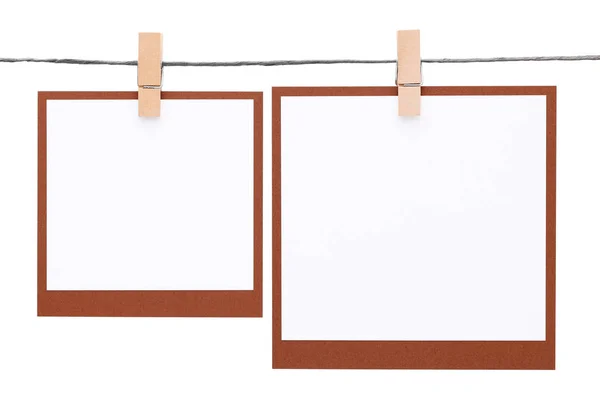 Blank instant photo hung on rope with clothespin — Stock Photo, Image