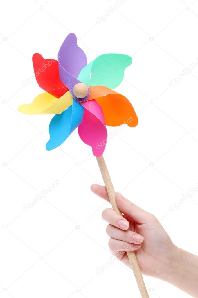 Hand holding colorful toy pinwheel 