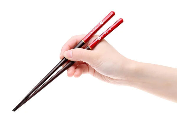 Hand holding red chopsticks — Stock Photo, Image