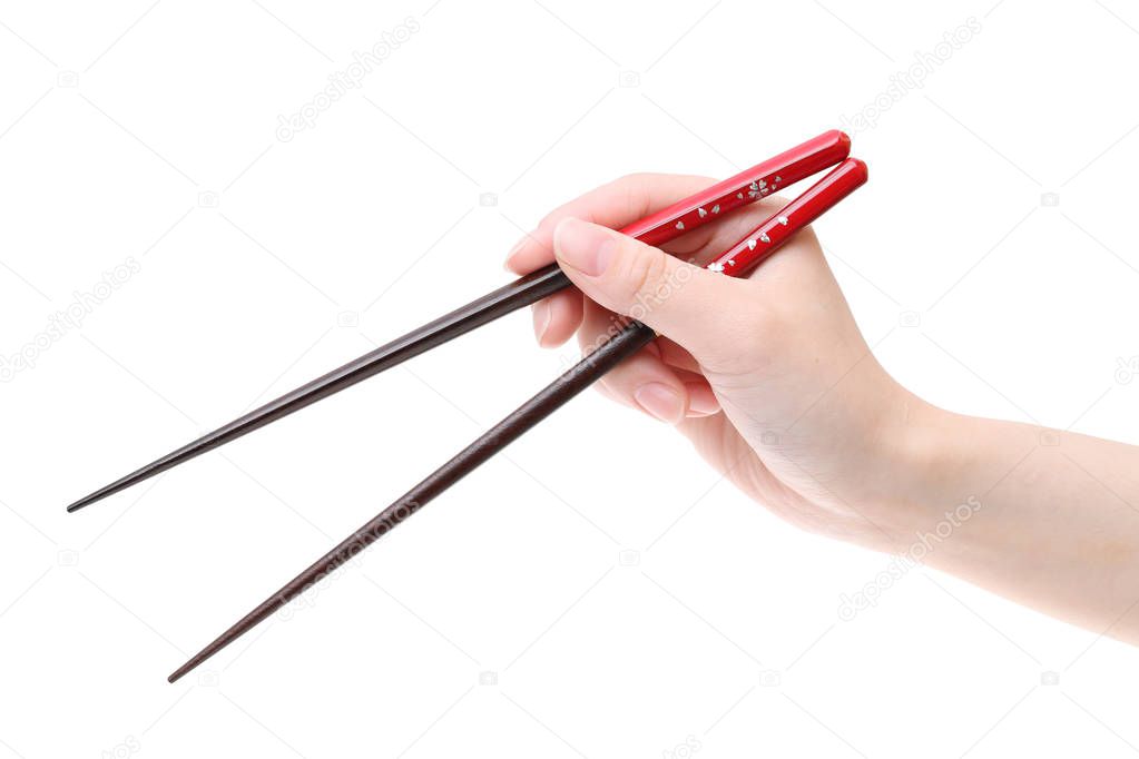 Hand holding red chopsticks