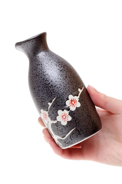 Hand holding japanese sake bottle — Stock Photo, Image